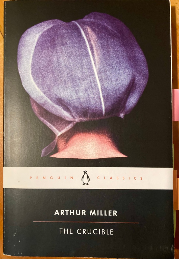 Cover of the Penguin edition of Arthur Miller's play, The Crucible. The image of the back of a woman's head who is wearing a white Puritan cap.